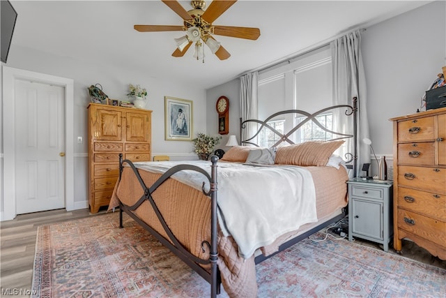 bedroom featuring hardwood / wood-style flooring and ceiling fan