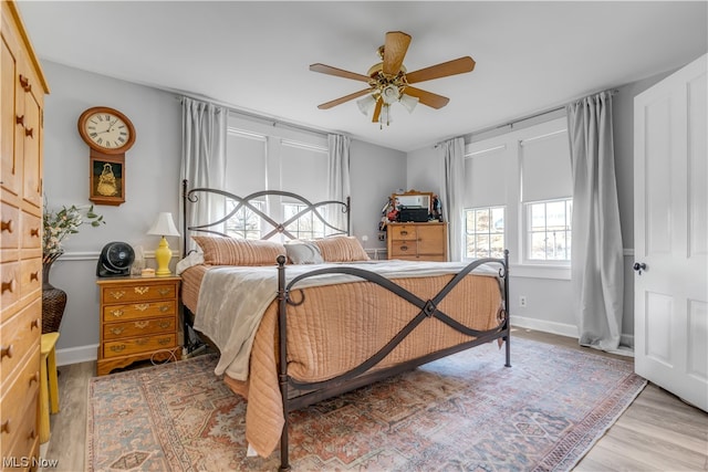 bedroom with ceiling fan and hardwood / wood-style floors