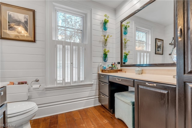 bathroom with vanity, wood-type flooring, and toilet