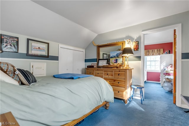 bedroom featuring carpet, a closet, and lofted ceiling