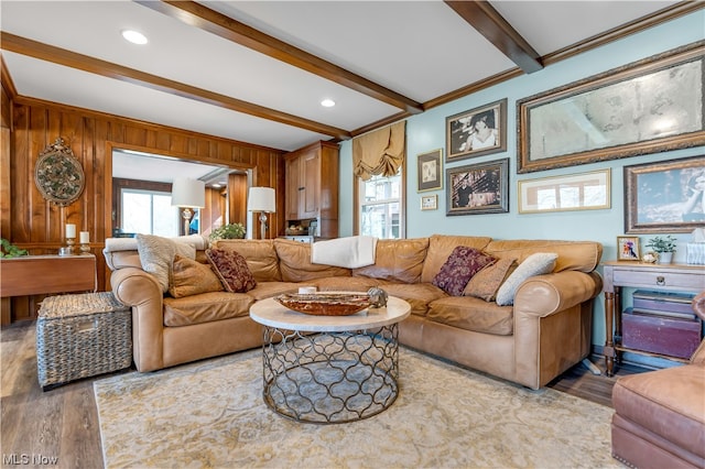 living room featuring wood walls, beam ceiling, and hardwood / wood-style flooring