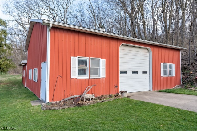 view of outbuilding with a garage and a lawn