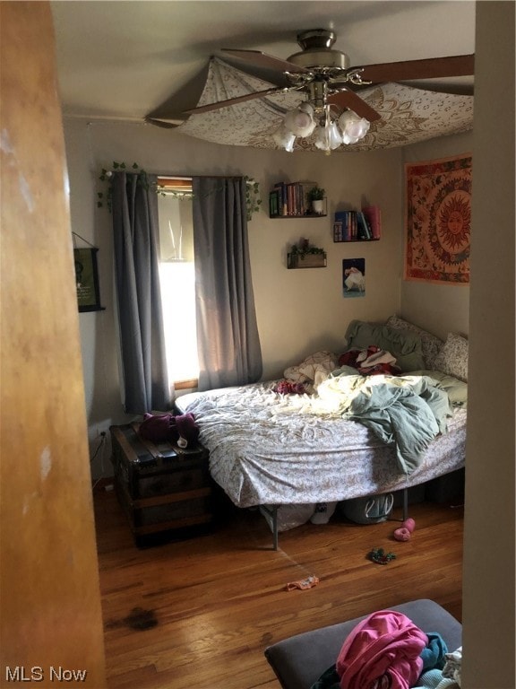 bedroom featuring hardwood / wood-style floors and ceiling fan