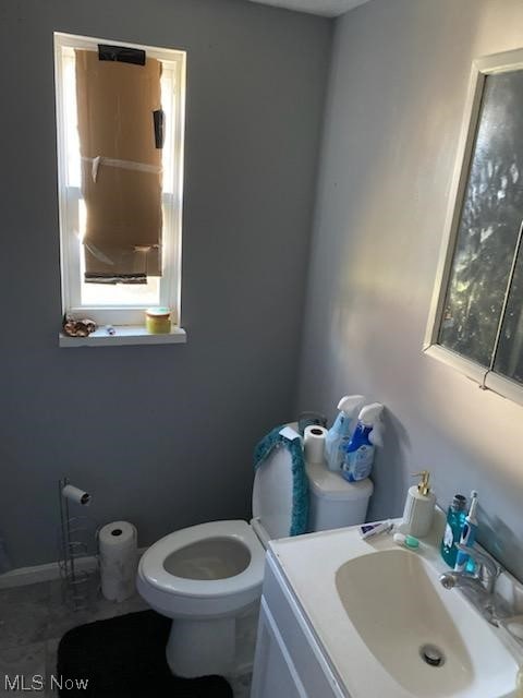 bathroom featuring tile patterned flooring, vanity, and toilet