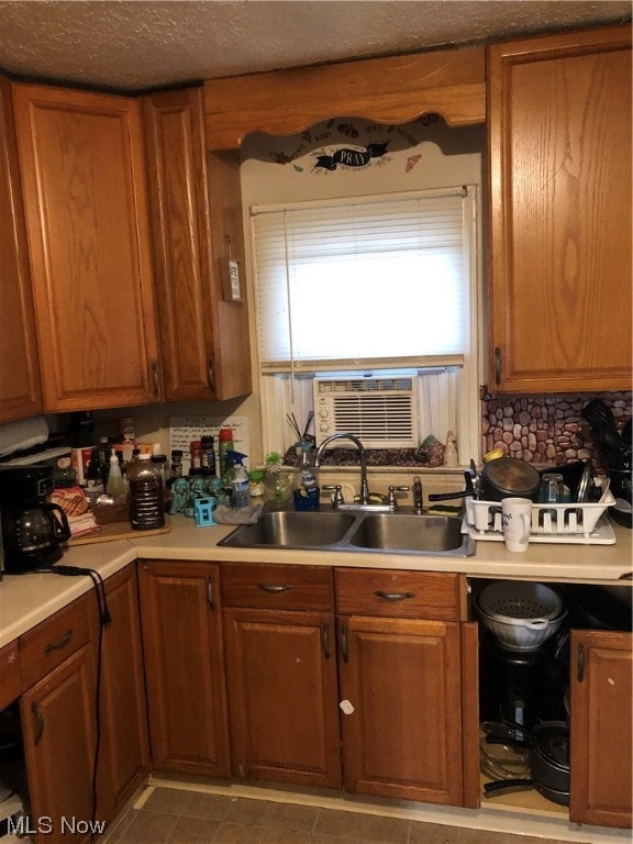 1351 E 340th St, Eastlake, OH 44095 - kitchen with cooling unit, dark tile patterned flooring, sink, decorative backsplash, and a textured ceiling