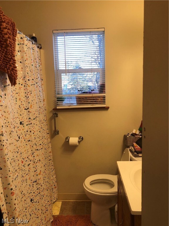 1351 E 340th St, Eastlake, OH 44095 - bathroom with tile patterned flooring, vanity, toilet, and a shower with shower curtain