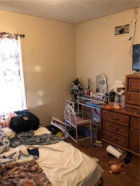 1351 E 340th St, Eastlake, OH 44095 - bedroom with hardwood / wood-style flooring and a textured ceiling
