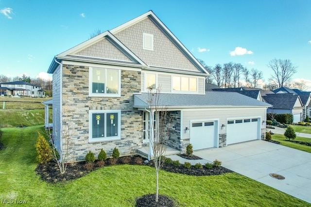 view of front of house with a front yard and a garage