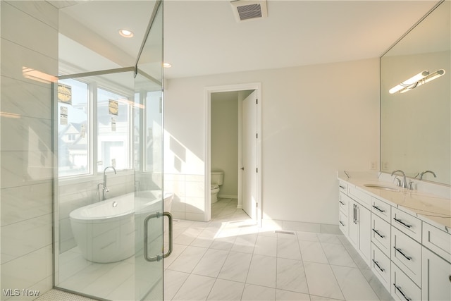 full bathroom with vanity, plus walk in shower, tile patterned flooring, toilet, and tile walls