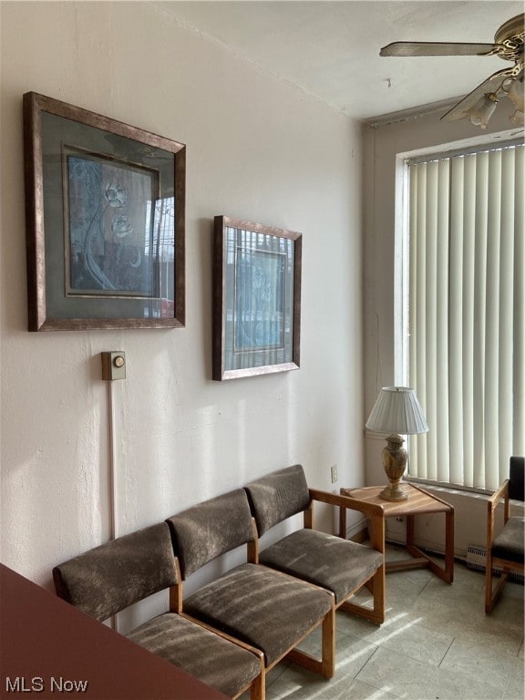 tiled living room with ceiling fan