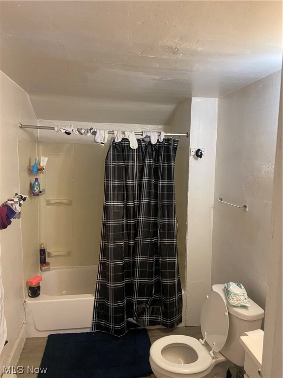 bathroom with shower / tub combo with curtain and toilet