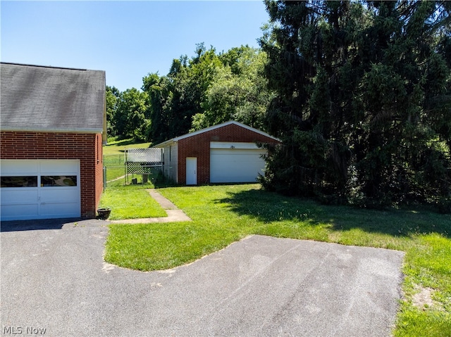 view of yard with an outbuilding and a garage