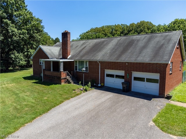 view of front of house featuring a garage and a front lawn