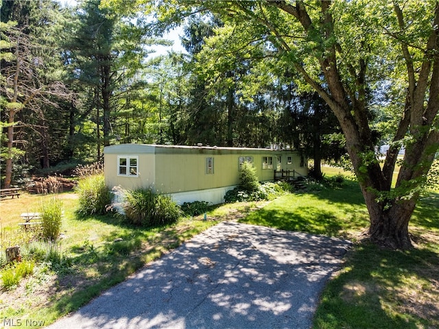 view of side of home featuring a yard