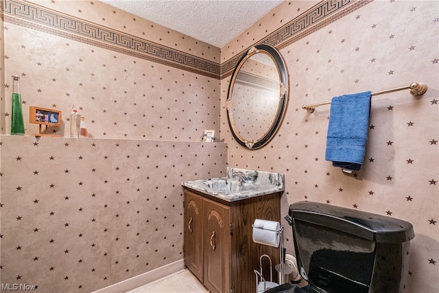 bathroom featuring a textured ceiling and vanity