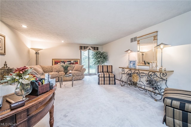 living room with a textured ceiling and light carpet