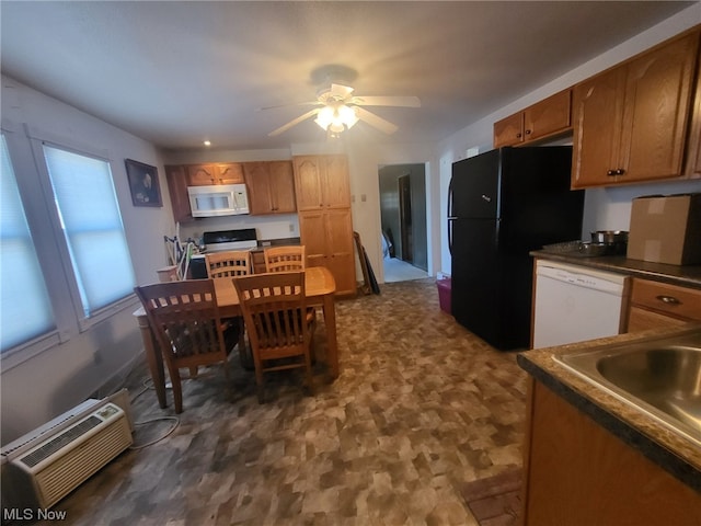 kitchen featuring a wall mounted air conditioner, ceiling fan, white appliances, and sink