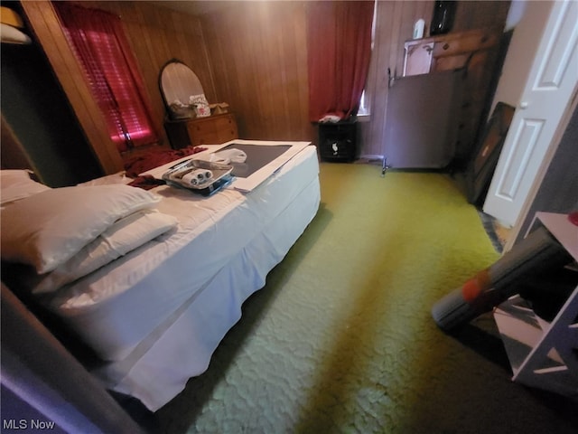 bedroom with wood walls and carpet floors