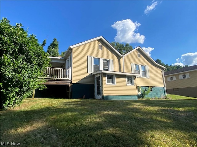 rear view of property with a lawn