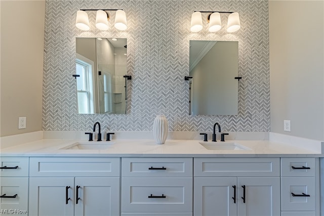 bathroom featuring backsplash, ornamental molding, and double sink vanity