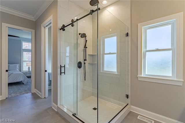 bathroom featuring tile flooring, a wealth of natural light, and a shower with door