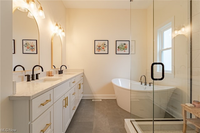 bathroom with separate shower and tub, tile floors, and dual bowl vanity