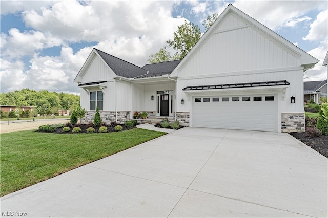 modern farmhouse featuring a front lawn and a garage