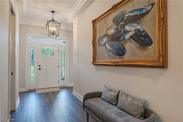 foyer with crown molding, dark hardwood / wood-style flooring, a notable chandelier, and a wealth of natural light