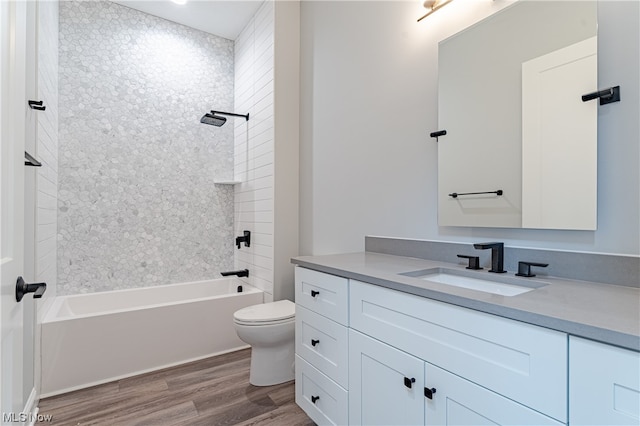 full bathroom with toilet, vanity, tiled shower / bath combo, and wood-type flooring