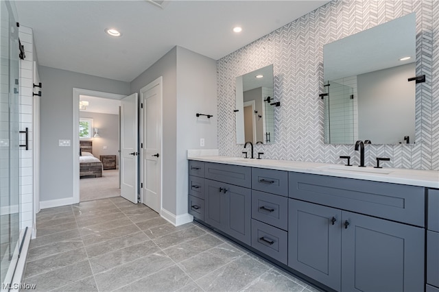 bathroom featuring backsplash, tile flooring, large vanity, and double sink