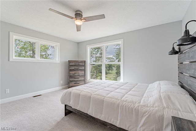 bedroom featuring light carpet and ceiling fan