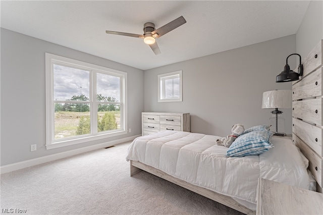 bedroom featuring ceiling fan and light colored carpet