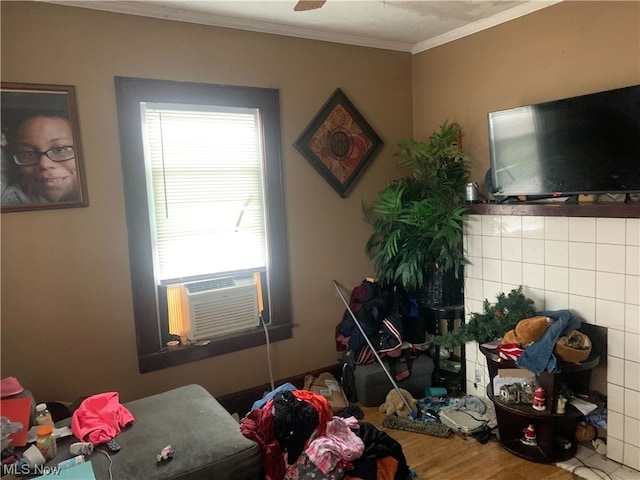 bedroom with multiple windows, crown molding, hardwood / wood-style flooring, and tile walls