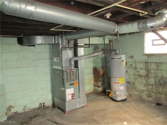 utility room featuring water heater and heating utilities