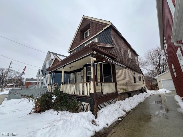 view of front of home with covered porch and a garage