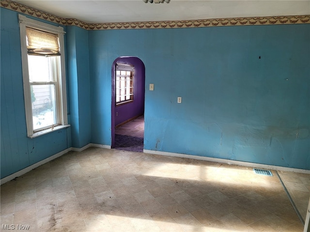 unfurnished room with light tile floors