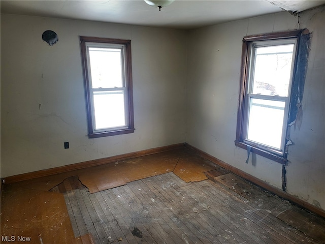 unfurnished room with dark wood-type flooring