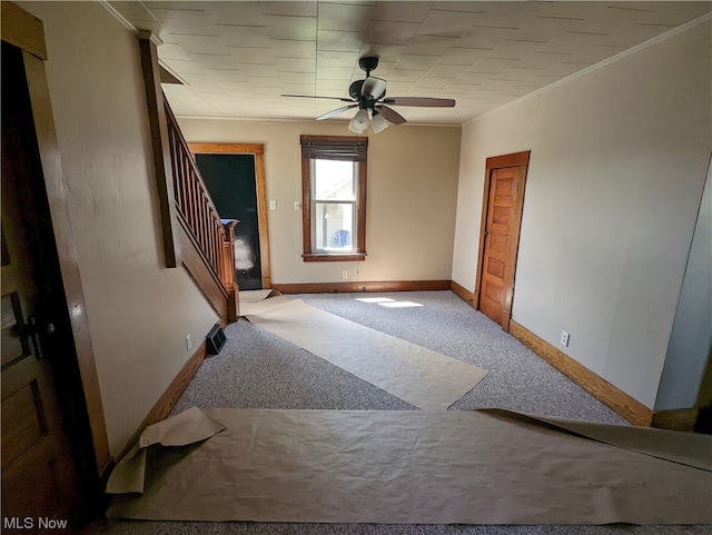 interior space featuring light colored carpet and ceiling fan