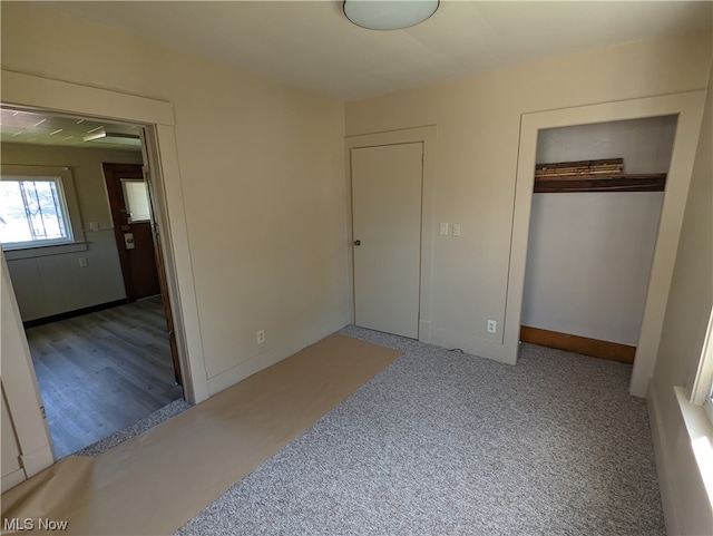 unfurnished bedroom featuring a closet and light wood-type flooring