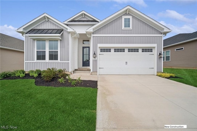 view of front facade with a garage, concrete driveway, board and batten siding, a standing seam roof, and a front yard