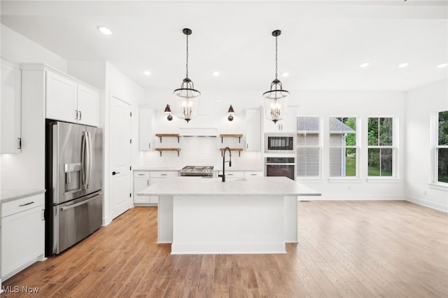 kitchen featuring recessed lighting, a sink, appliances with stainless steel finishes, open shelves, and light wood finished floors