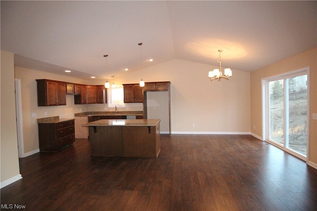 kitchen with an inviting chandelier, a center island, dark hardwood / wood-style floors, and decorative light fixtures