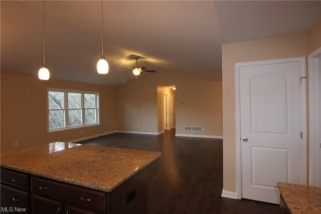 kitchen with dark brown cabinetry, dark hardwood / wood-style floors, pendant lighting, light stone countertops, and ceiling fan