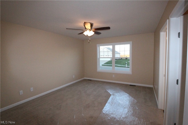 carpeted spare room featuring ceiling fan