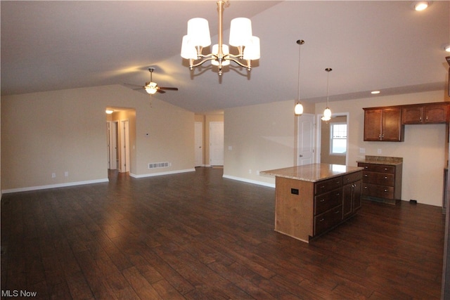 kitchen with hanging light fixtures, dark hardwood / wood-style flooring, ceiling fan with notable chandelier, and a center island