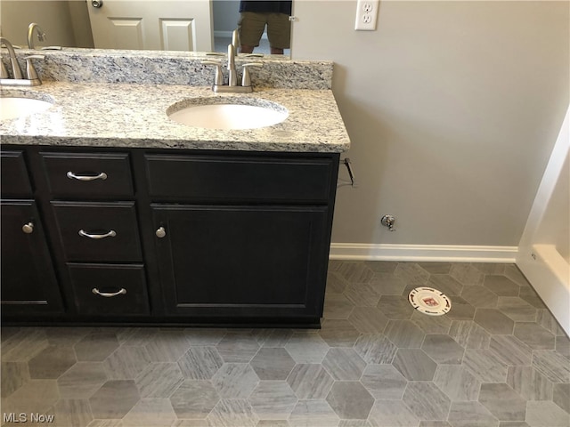 bathroom featuring double sink vanity and tile floors