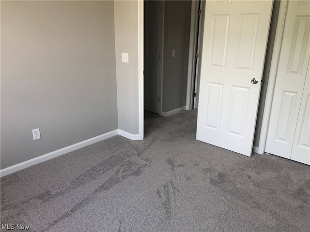 empty room with dark carpet