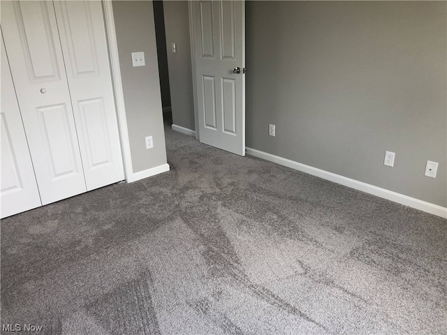 unfurnished bedroom featuring dark colored carpet