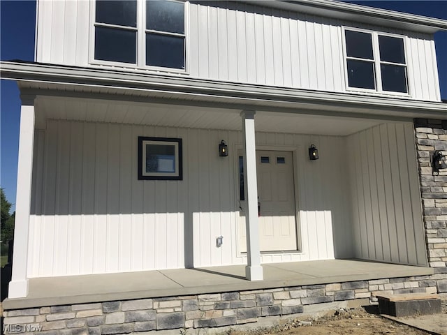 view of exterior entry featuring a porch