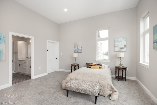 carpeted bedroom with ensuite bathroom